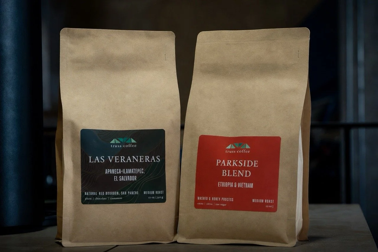 Two coffee bean bags of local Washington DC coffee cart, Truss Coffee. The bag on the left is Las Veraneas, and the right is Parkside Blend