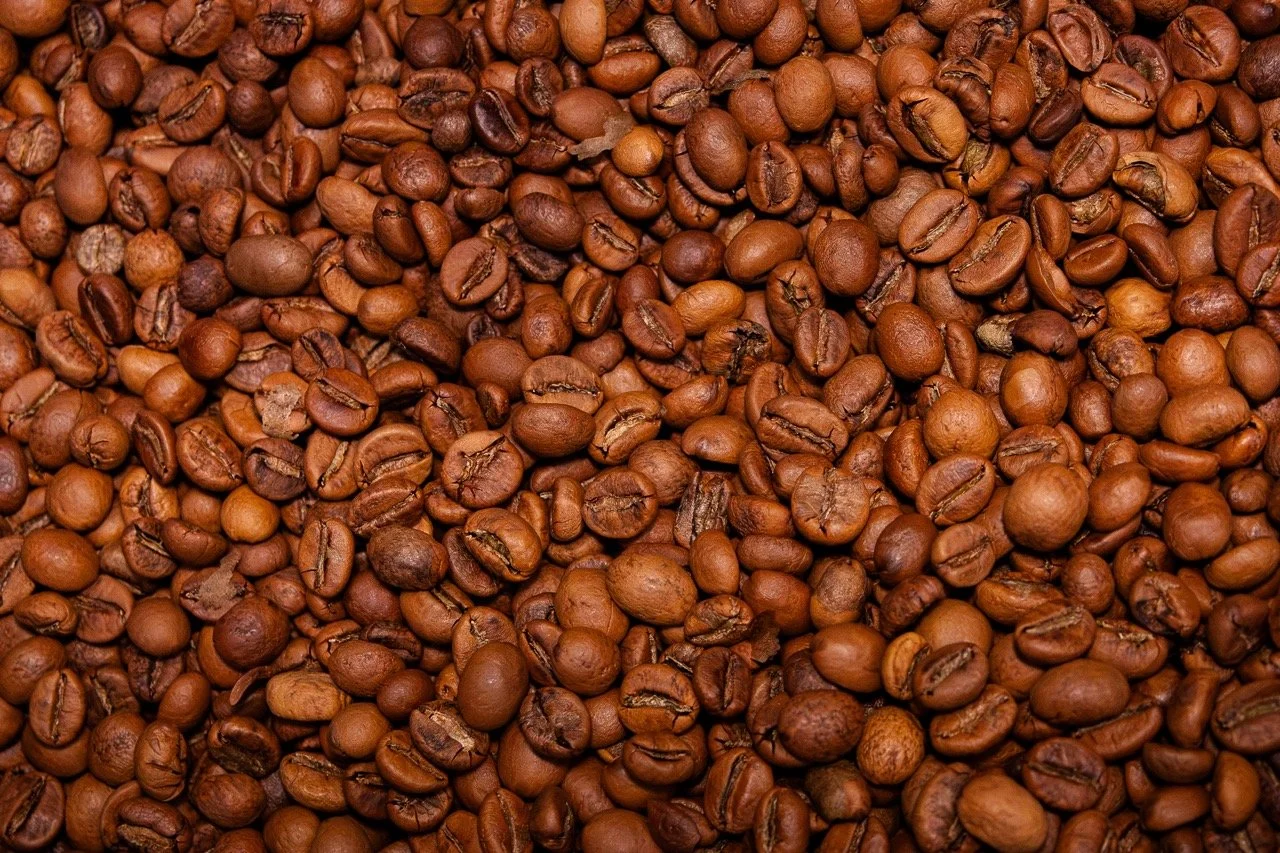 brown coffee beans jumbled together tightly for a brand photography picture