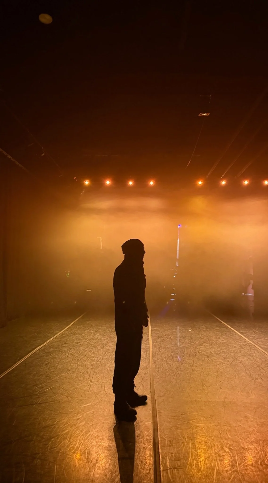 Jim Bunting stands on stage before the opening night of Crystal Ball by Michaela Delaney Guthrie