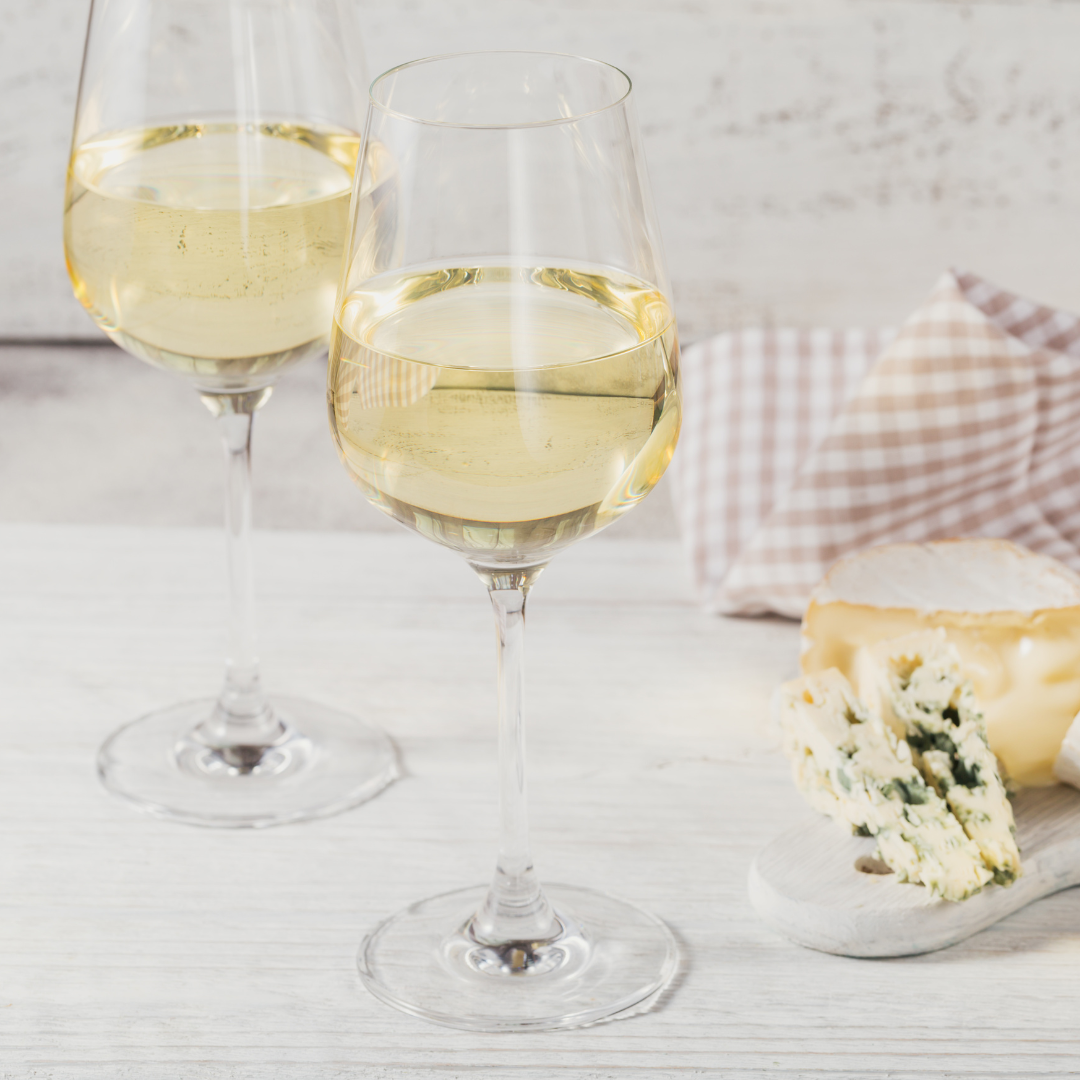 glasses of white wine and some cheeses