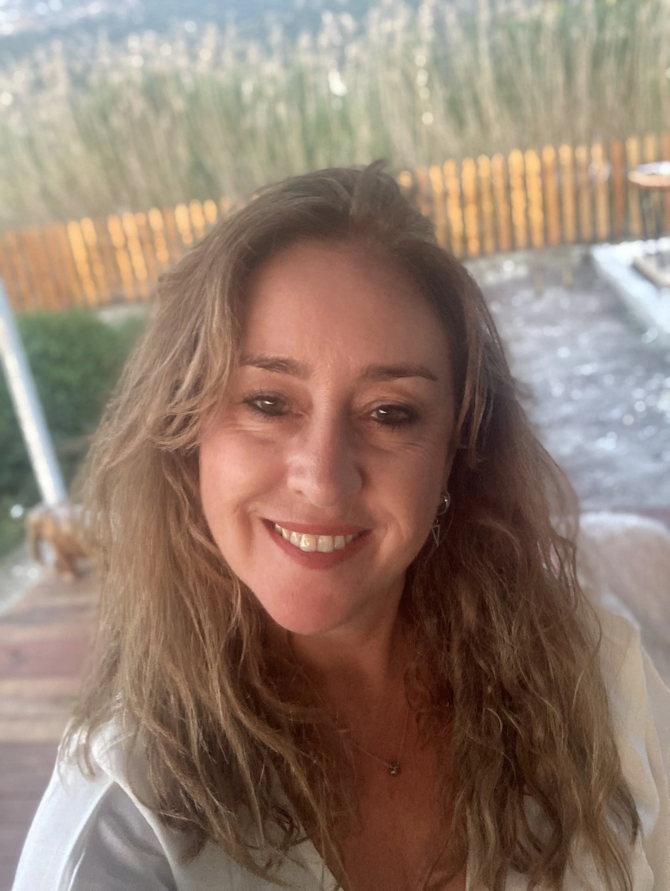 A smiling woman with blonde hair