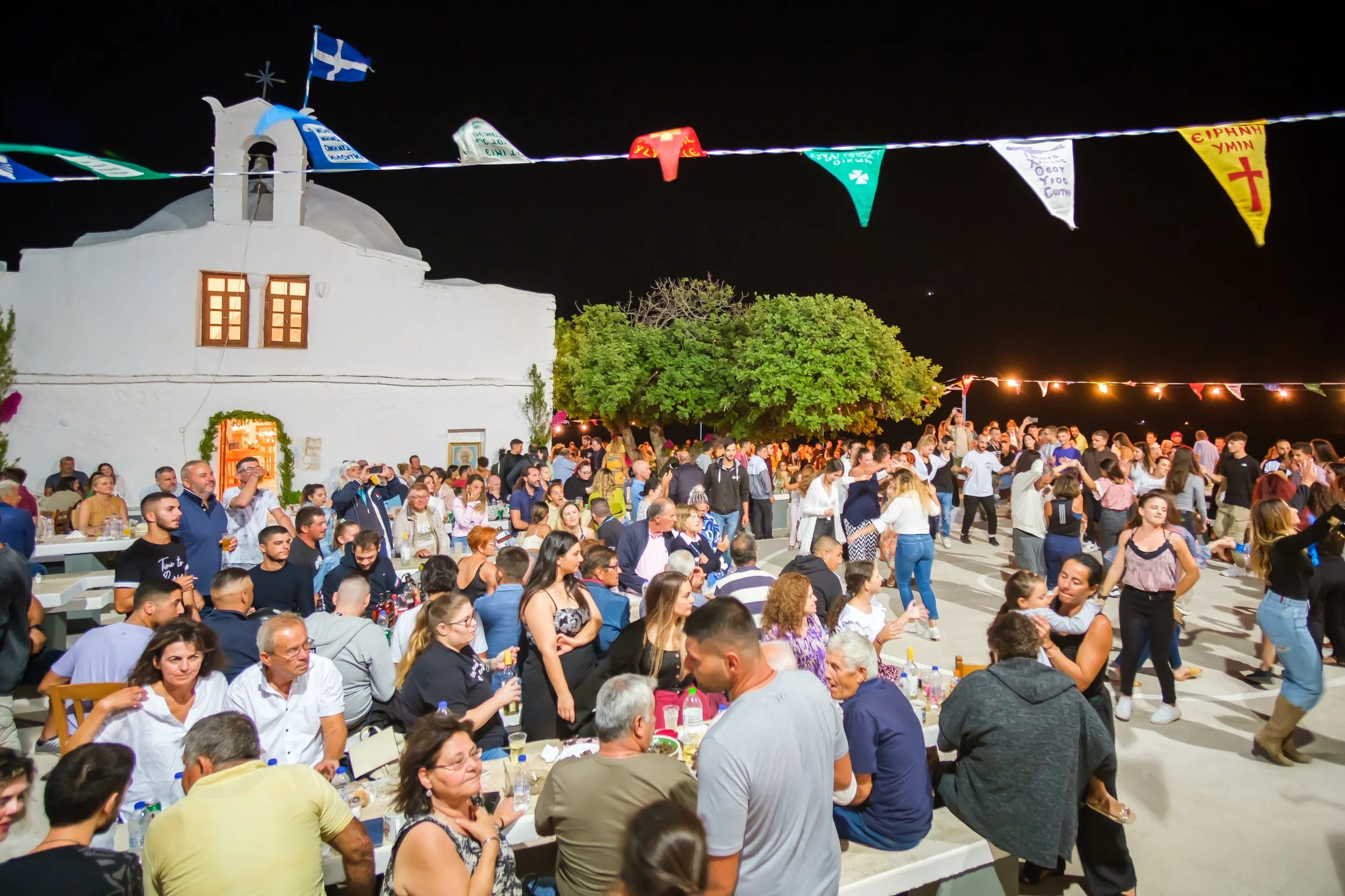 People dancing at an outdoor party in greece