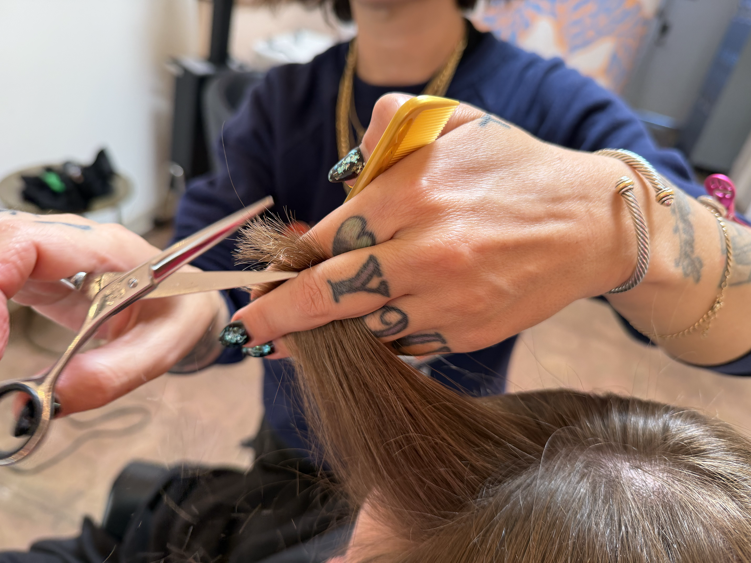 Stylist cutting hair at Good Look Babe hair salon in La Mesa