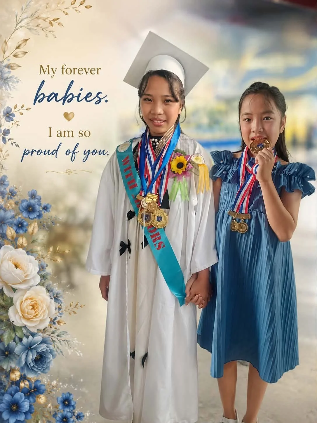 Two young girls celebrating graduation, one in a white gown and cap, holding hands, adorned with medals, ribbons, and a flower. The other in a blue dress, holding a medal near her mouth. There are decorative flowers on the left, and text on the left 