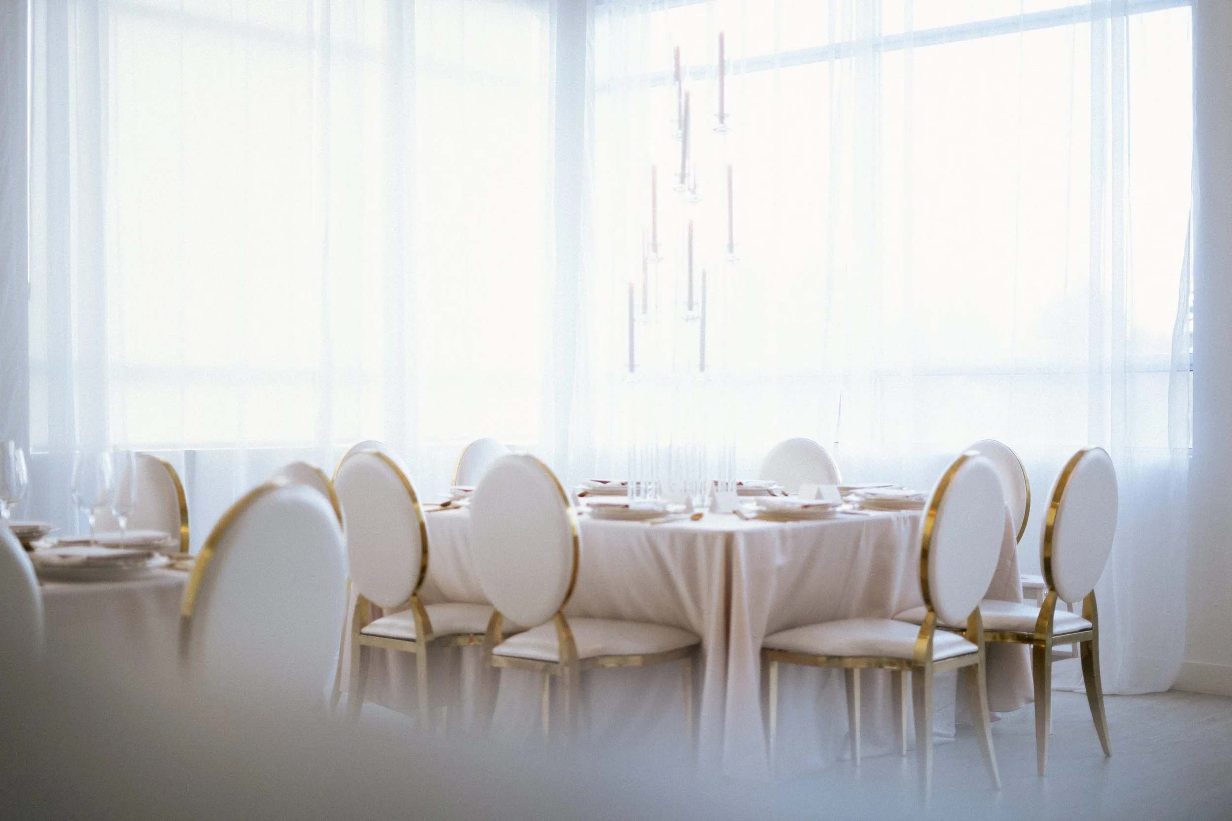 Elegant wedding reception table setup with white linens and gold chairs, luxury event rentals in Tri-Cities WA by Luna Event Rentals.