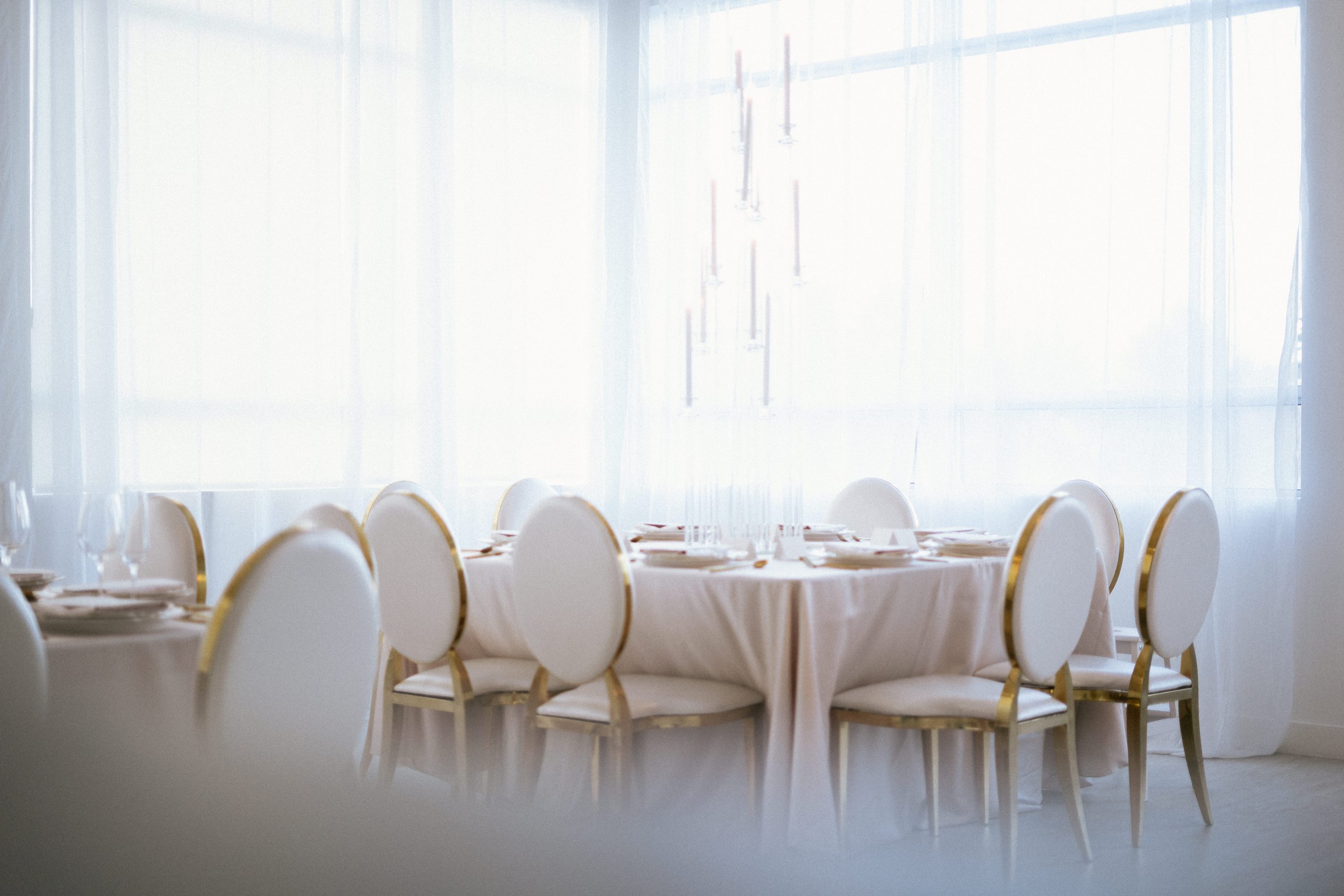 Elegant wedding reception table setup with white linens and gold chairs, luxury event rentals in Tri-Cities WA by Luna Event Rentals.