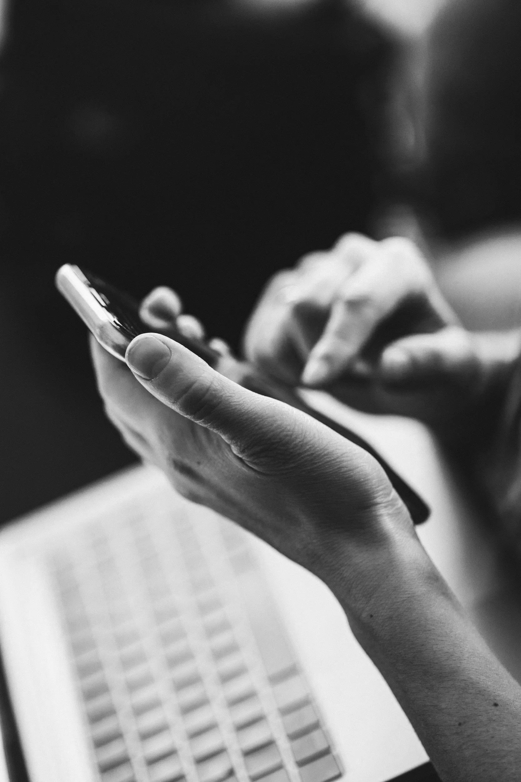 Photograph of a person typing an email on a mobile phone