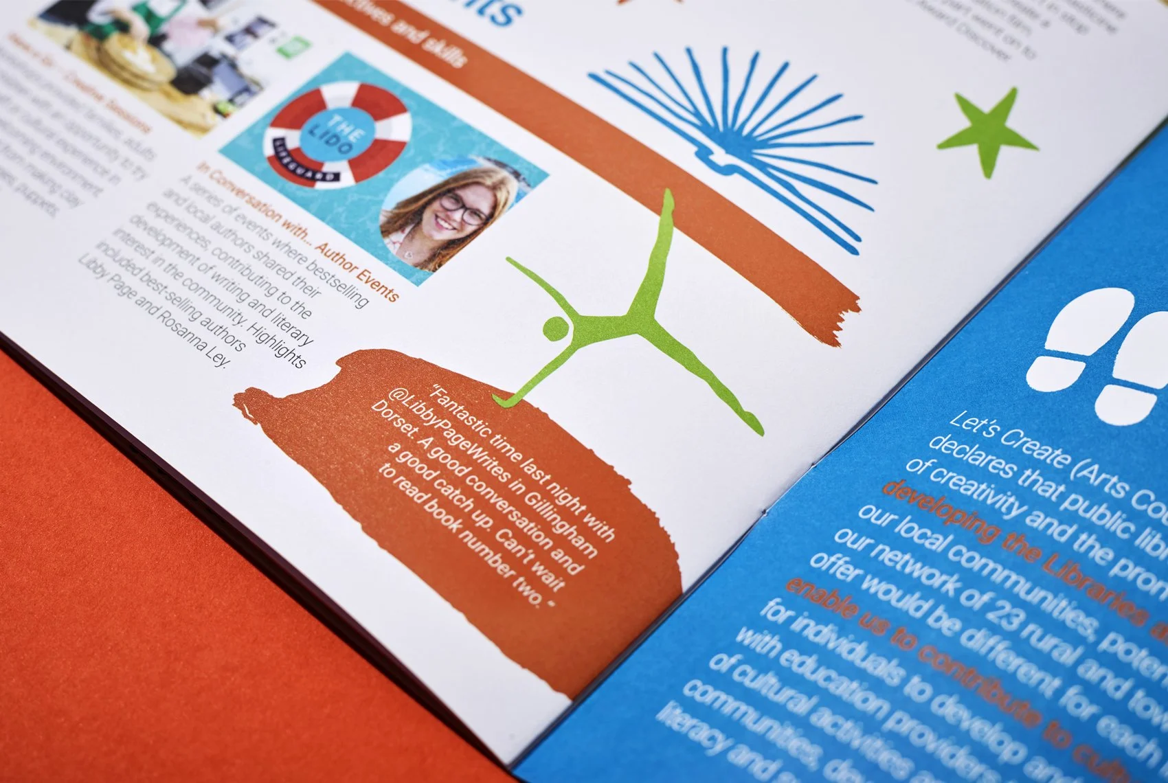 Close-up of a page from a publication, featuring an illustration of a green tree on an orange background, a photograph of a smiling woman with glasses and red hair, and a map outline of Dorset with a quote about a last night meeting in Gillington. There is also a blue section with white and orange text about creating and developing the library community.