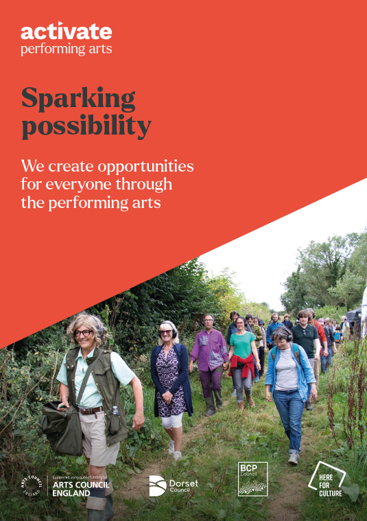 People participating in an outdoor event or walk along a trail surrounded by nature.