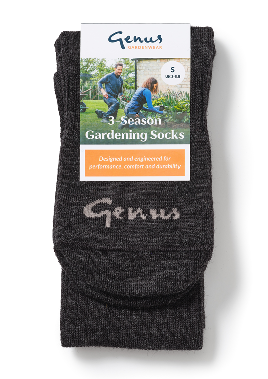 Black gardening socks with the brand name 'Genu' knitted on the bottom, attached to packaging featuring a photo of two people gardening outdoors.