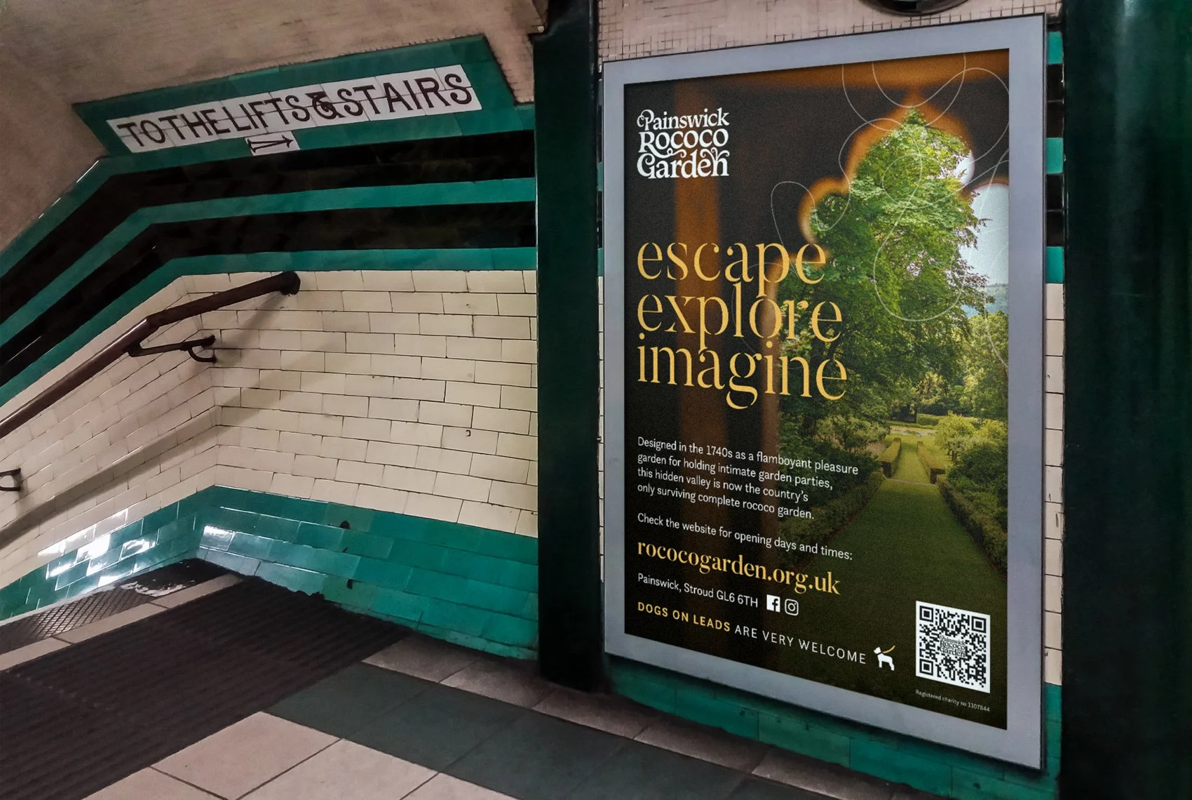 A sign and an entrance to the Rococo Garden with an escalator going down. The adjacent sign promotes the garden as a place to escape, explore, and imagine, and gives the website rococogarden.org.uk for more information.
