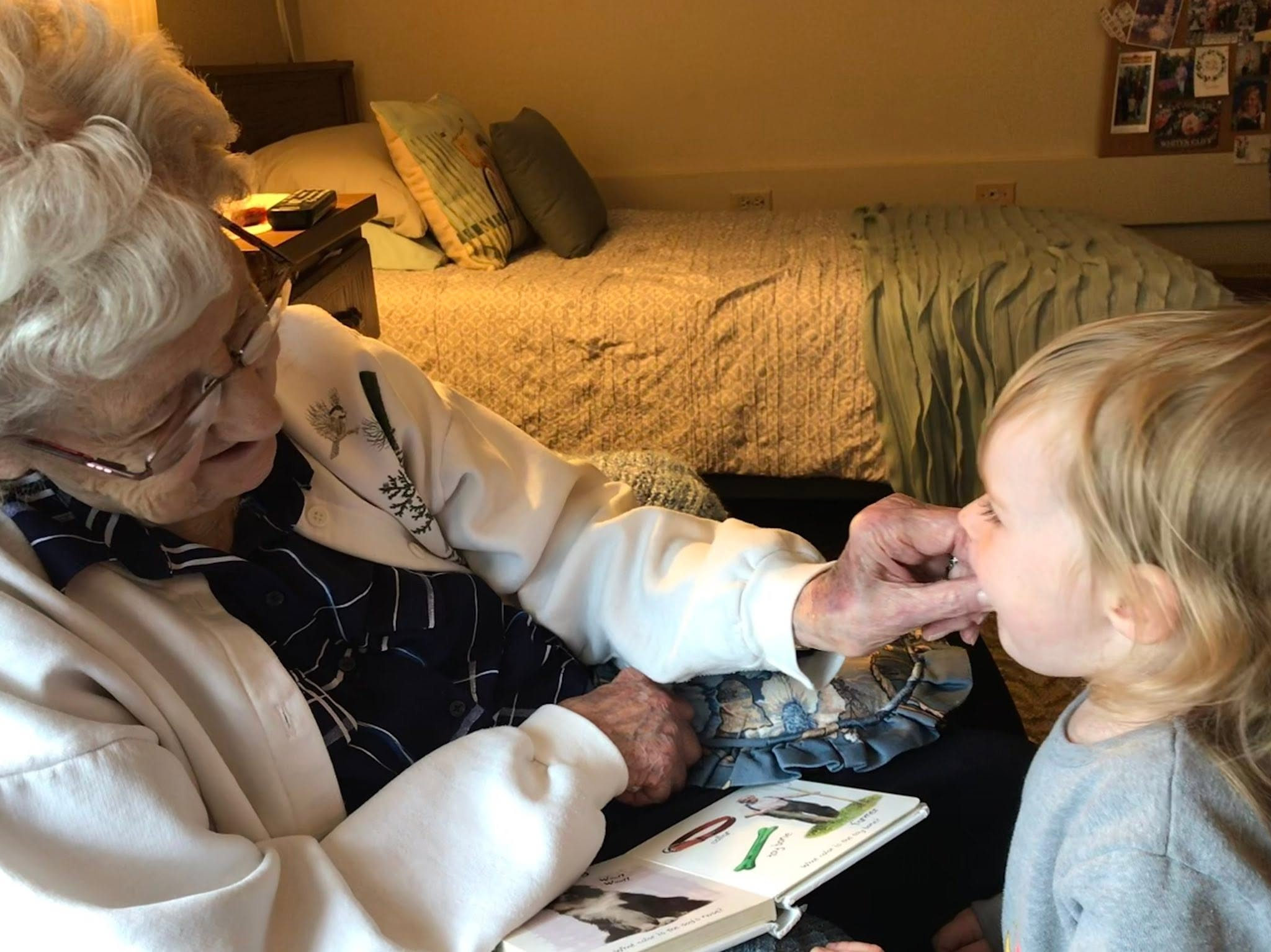Clarice sharing a book with a young child