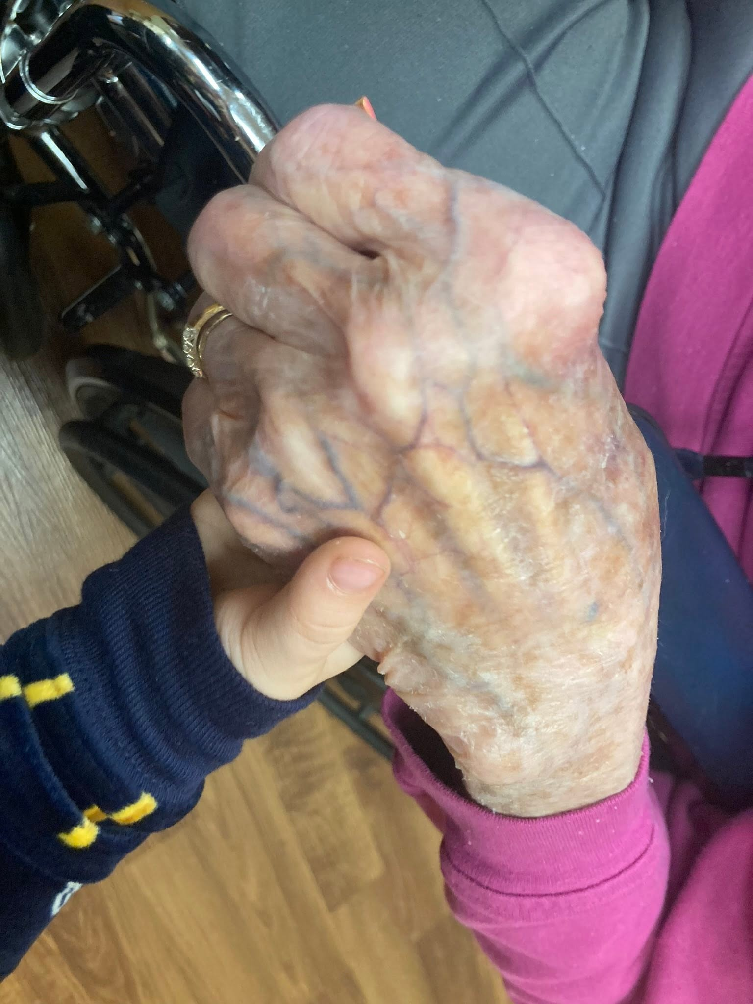 Clarice’s hand held by a small child