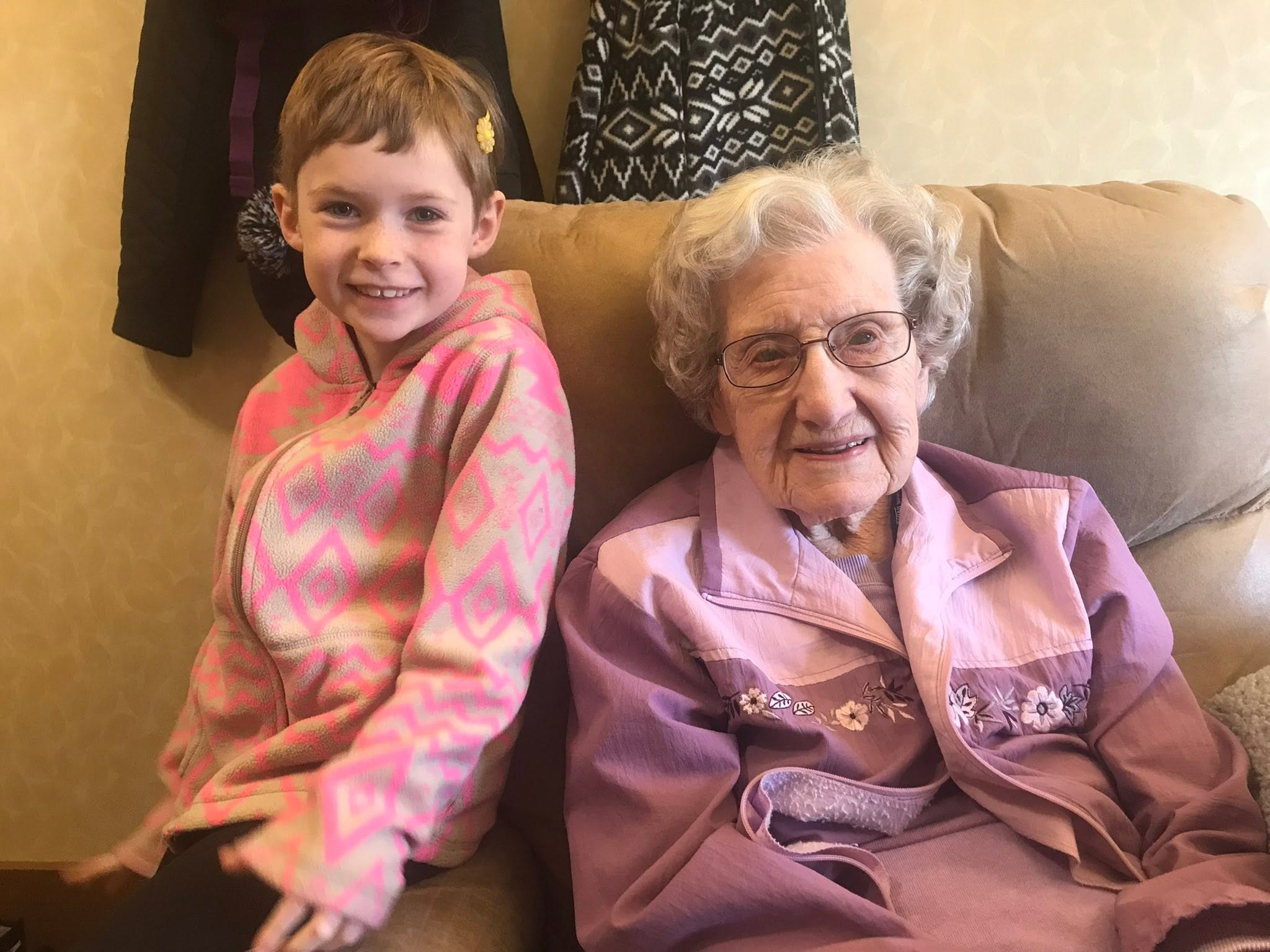 Clarice seated beside a smiling young girl