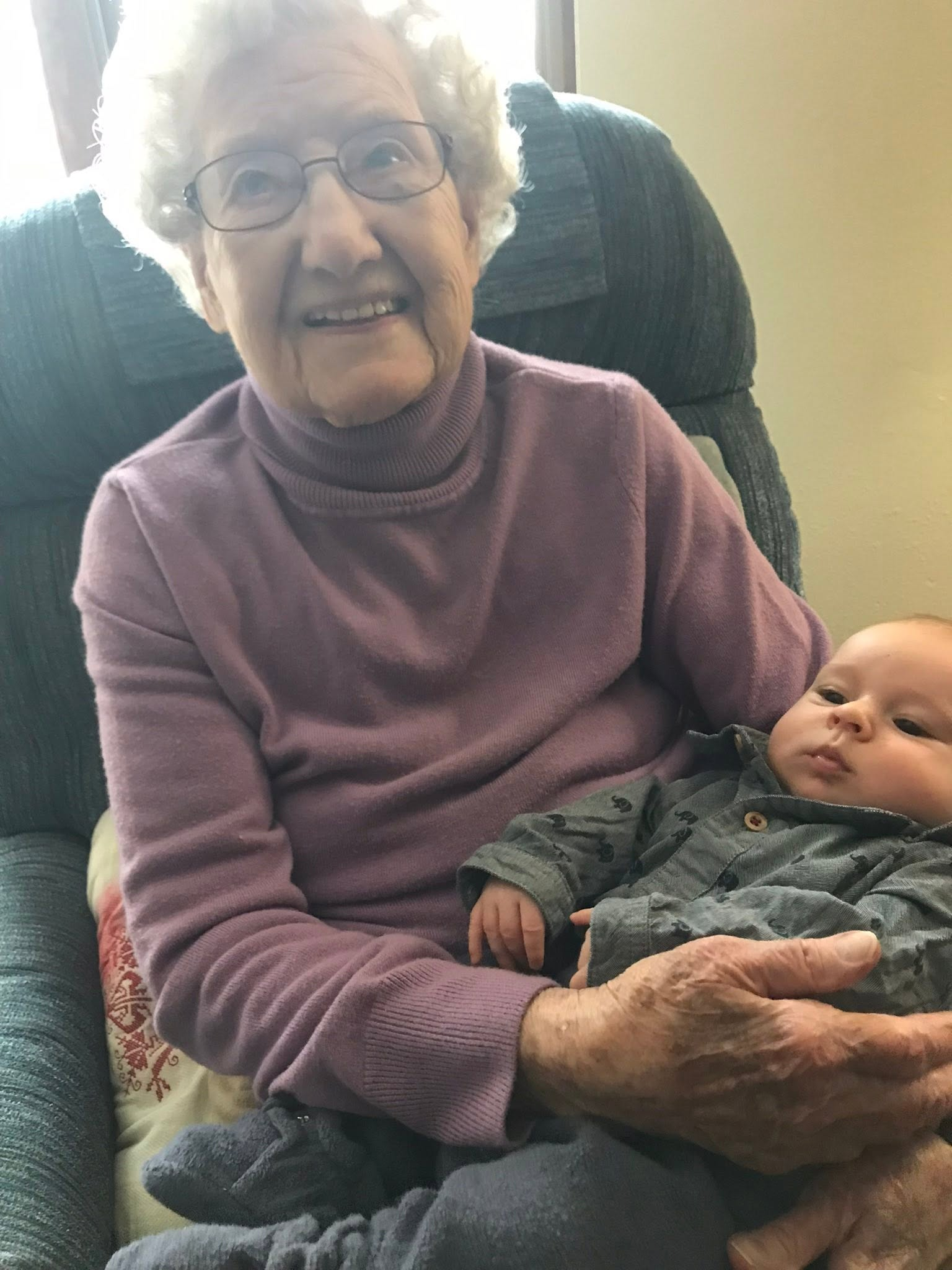 Clarice smiling while holding a baby