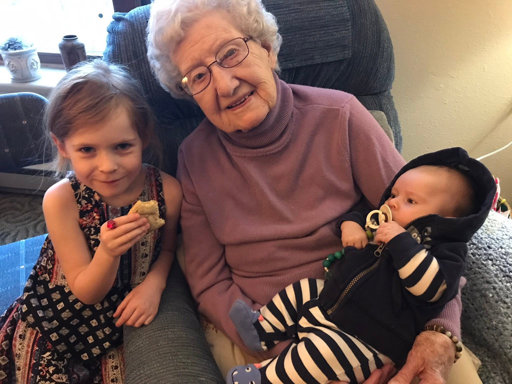 Clarice Skjonsby seated with two children