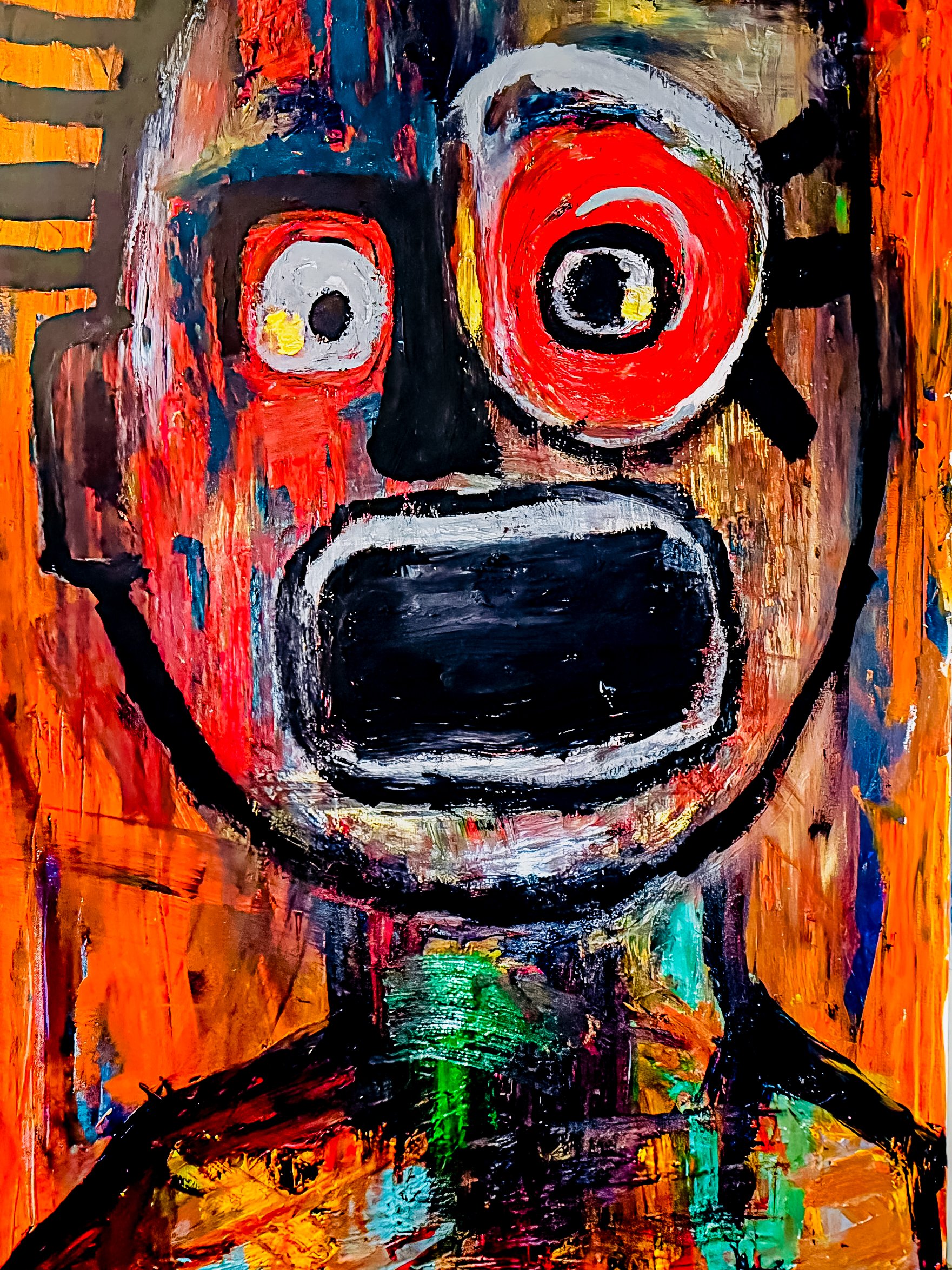 A colorful, abstract painting of a face with exaggerated features, including large red eyes, a big open black mouth, and a black nose. The background is vibrant with orange, red, green, and blue brushstrokes.