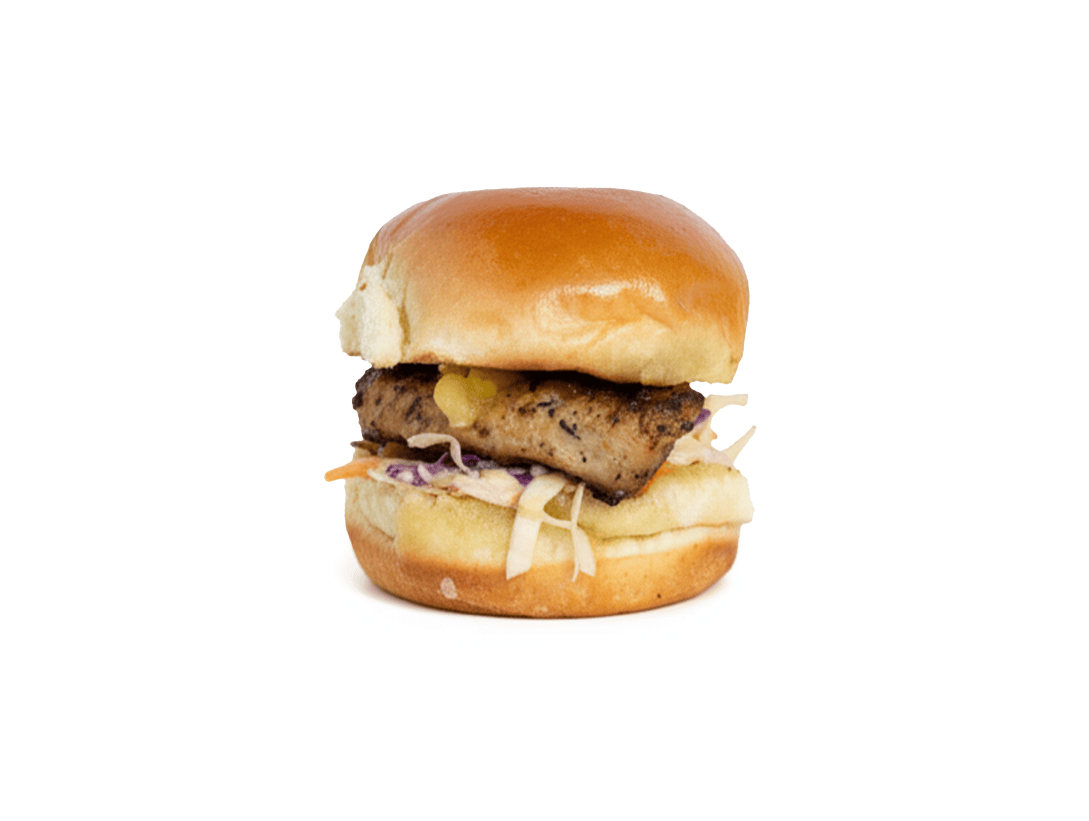 Slip Sliders Caribbean Chick sandwich with grilled chicken, jerk seasoning, Slip Slaw, and grilled pineapple.