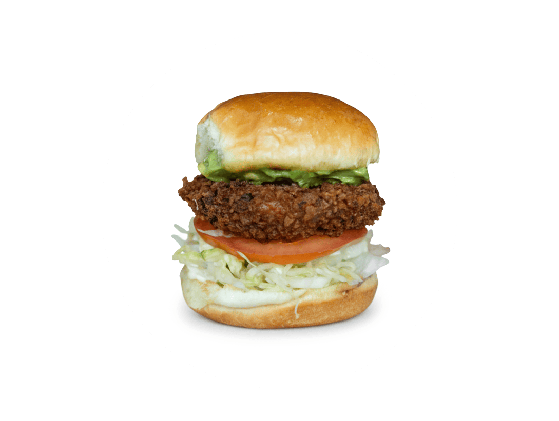 Slip Sliders Shrimp Shack sandwich featuring shrimp cake, lettuce, tomato, avocado, and mayo.