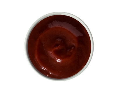 A white bowl filled with ketchup, viewed from above.