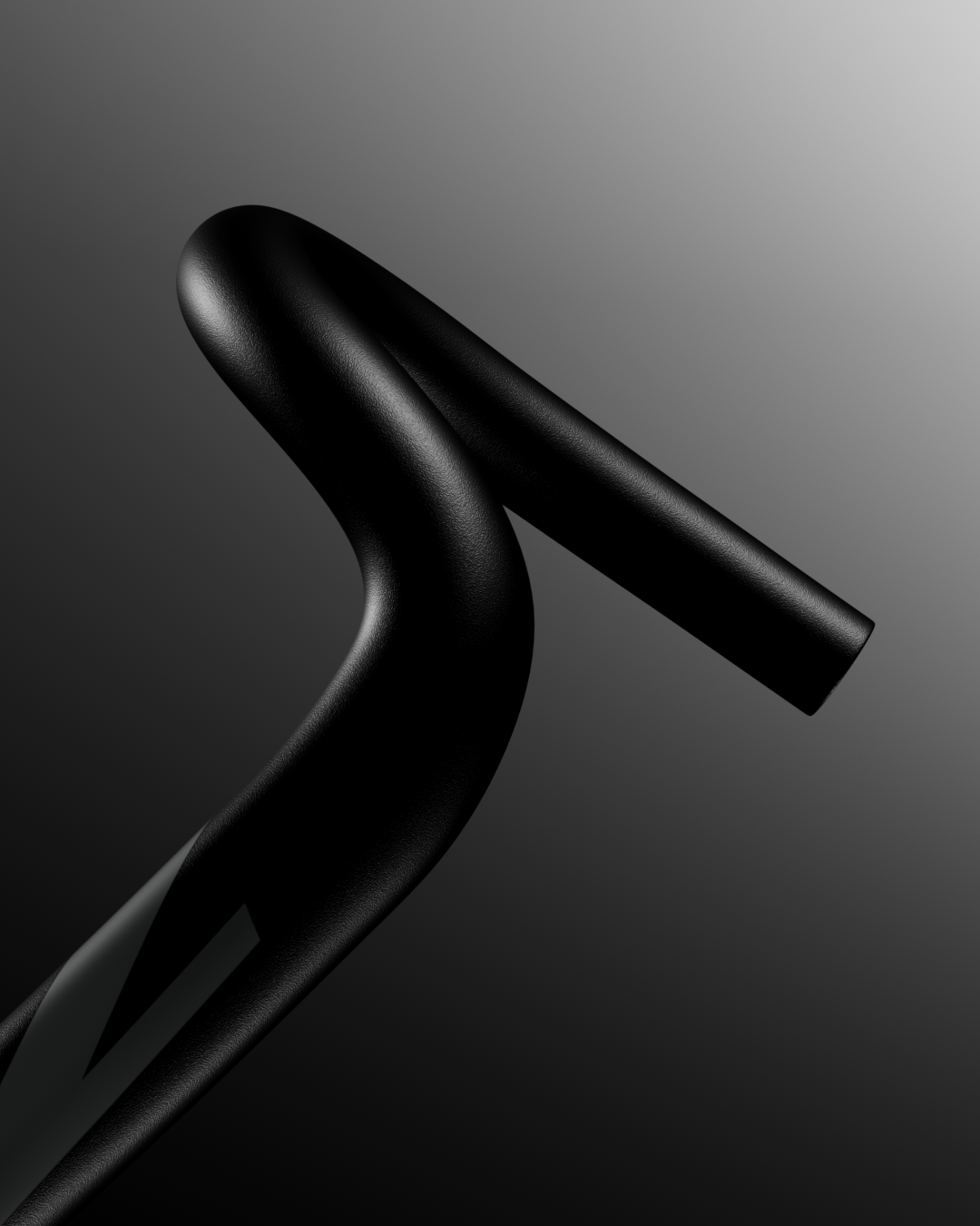 Manubrio di una bicicletta nera in primo piano con sfondo sfumato