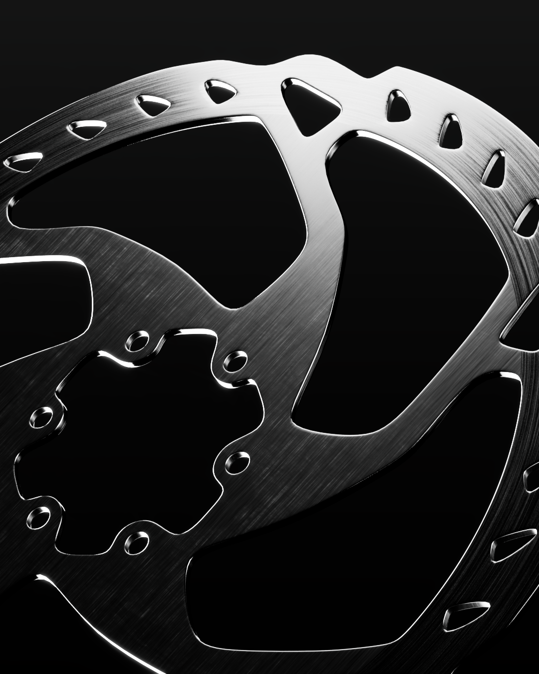 Particolare di un disco freno in acciaio inossidabile con fori di ventilazione, sfondo nero.