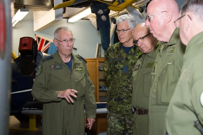  404 (Long Range Patrol and Training) Squadron Honorary Colonel Eric Wood, and Greenwood Military Aviation Museum volunteer, conducts a tour of the museum with visiting Royal Canadian Air Force honorary colonels June 8. Corporal K. Neate, 14 Wing Ima