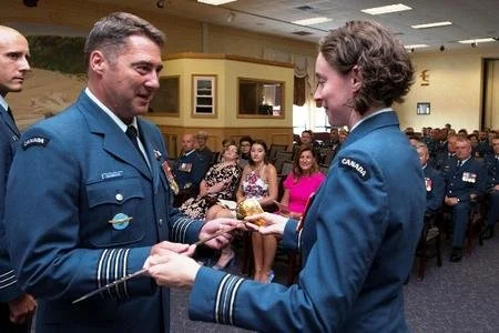  14 Wing Greenwood Commander Colonel Mike Adamson presided over the exchange of 14 Operations Support Squadron command – and the command sabre – July 25, between the outgoing Major Tania Maurice, left, and the incoming Lieutenant-Colonel Brent Vaino.