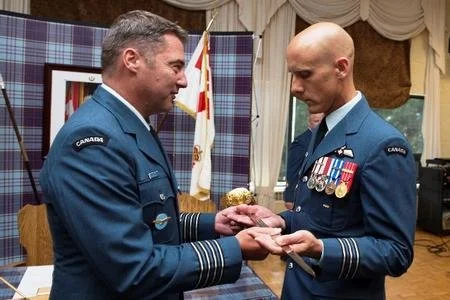  14 Wing Greenwood Commander Colonel Mike Adamson presided over the exchange of 14 Operations Support Squadron command – and the command sabre – July 25, between the outgoing Major Tania Maurice, left, and the incoming Lieutenant-Colonel Brent Vaino.