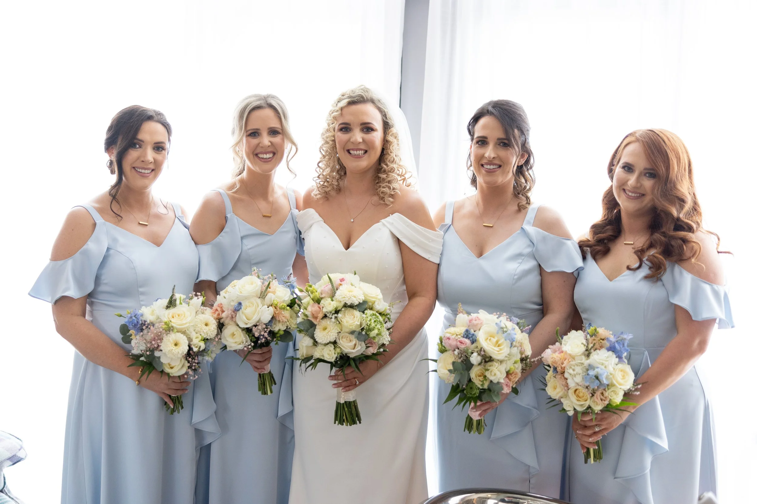 blonde curly hair bride and bridesmaids