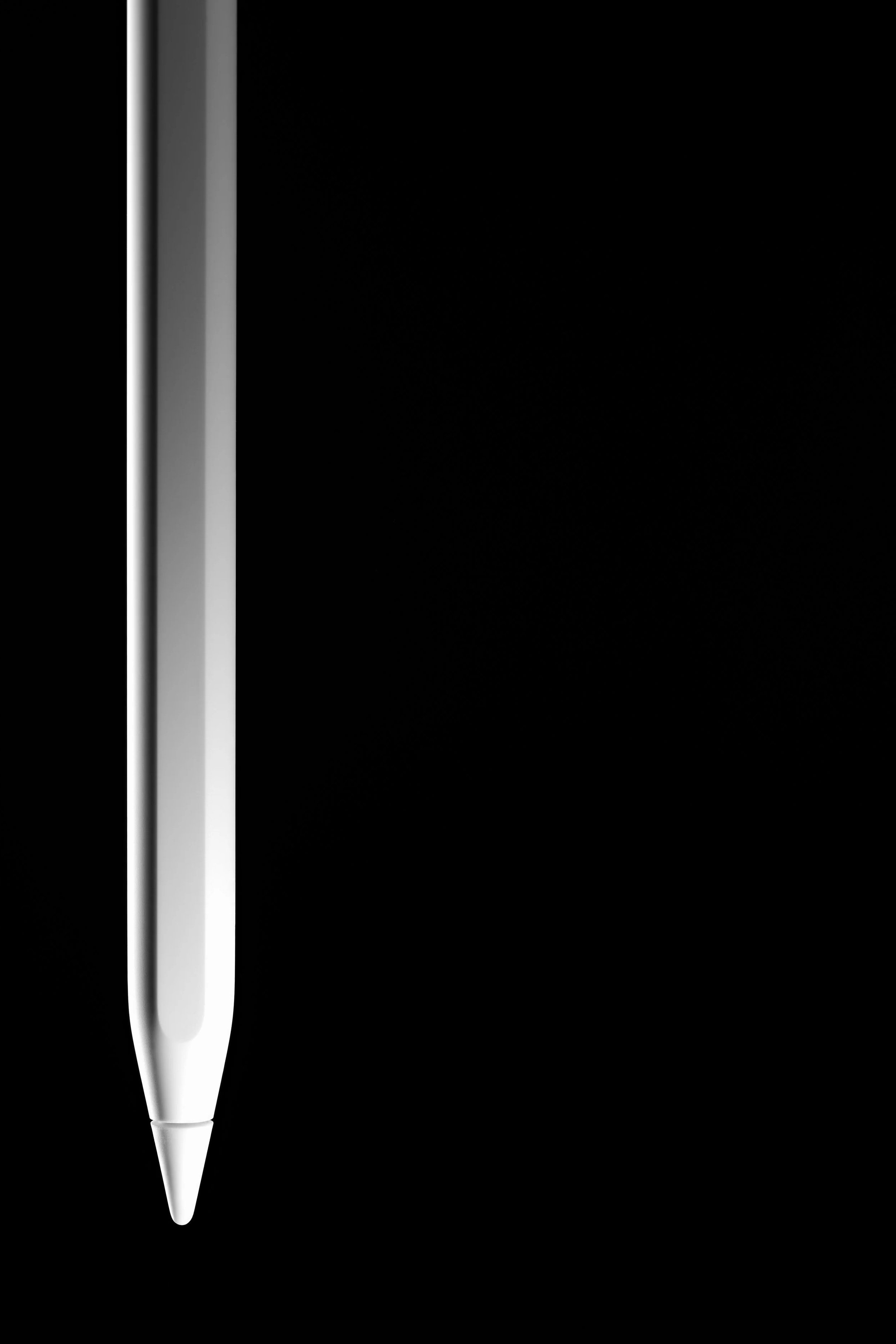 Un stylo apple pen moderne en acier inoxydable blanc placé verticalement sur un fond noir.