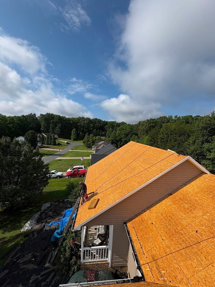sturdy plywood boards cover the roof of a home before a new roof is installed 