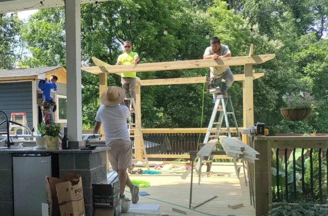 A team of experts builds a custom outdoor entertainment area with pergola in Greensboro NC