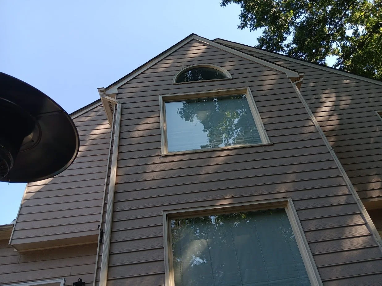 shade soaks the side of a home with newly installed siding
