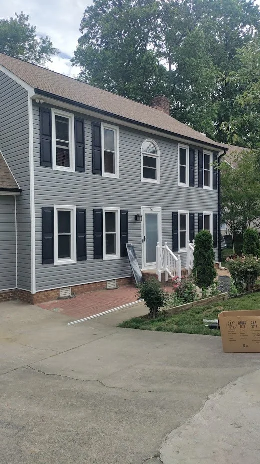 A home made picture perfect with siding and shingle replacement.