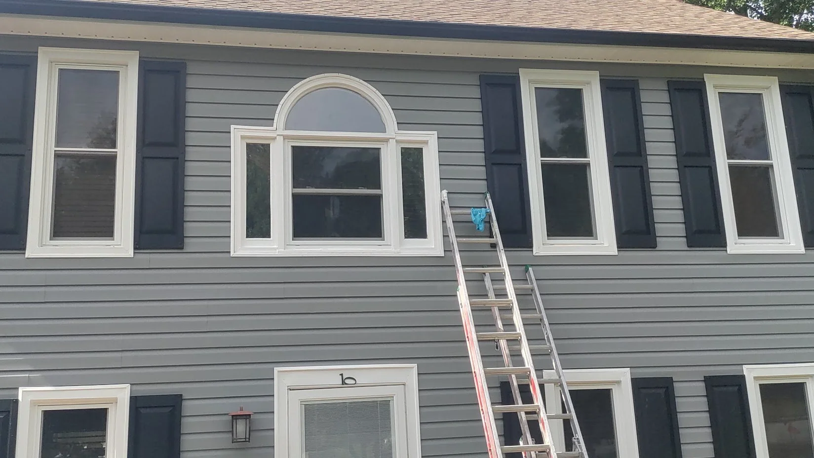 New custom siding installation completed around a half round window.