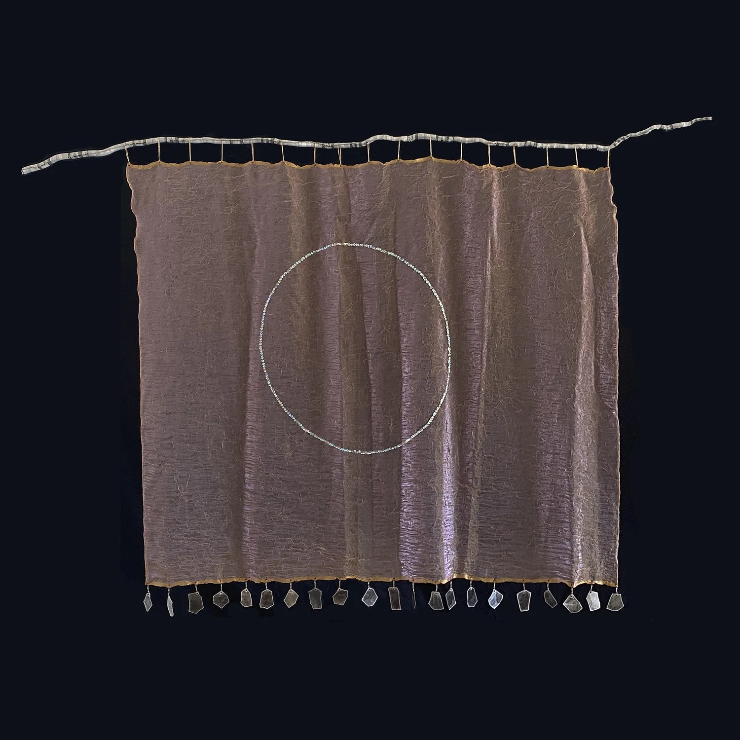 OM  
By Merridee LaMantia
branch: 7'-2" (L),  fabric: 5'-4" (W) x 5'-2" (H)
Artist grown Curly Willow branch (fabric-wrapped), iridescent fabric, sequins, Mica
2004