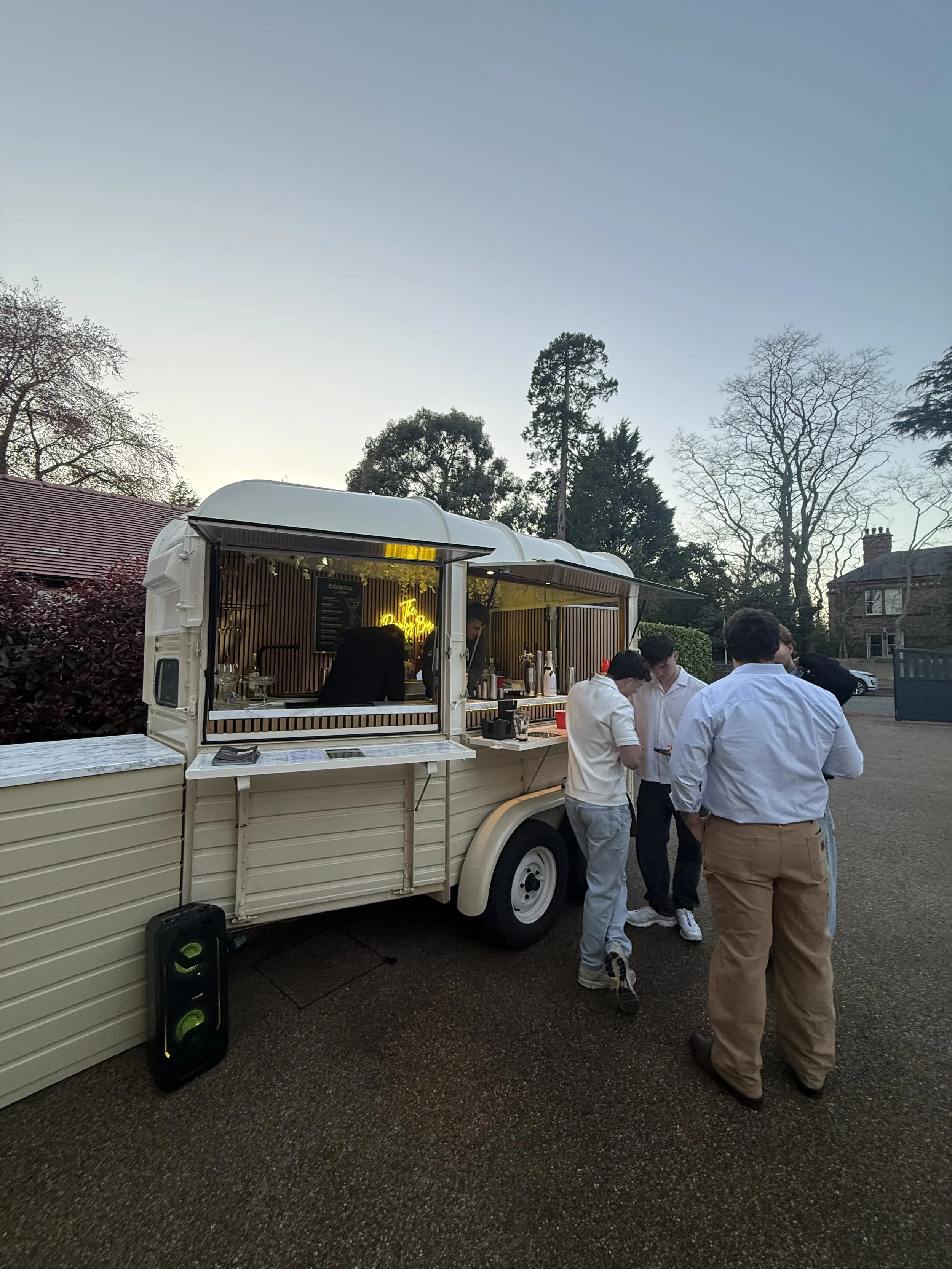 people gathered outside the horsebox bar sipping drinks and chatting