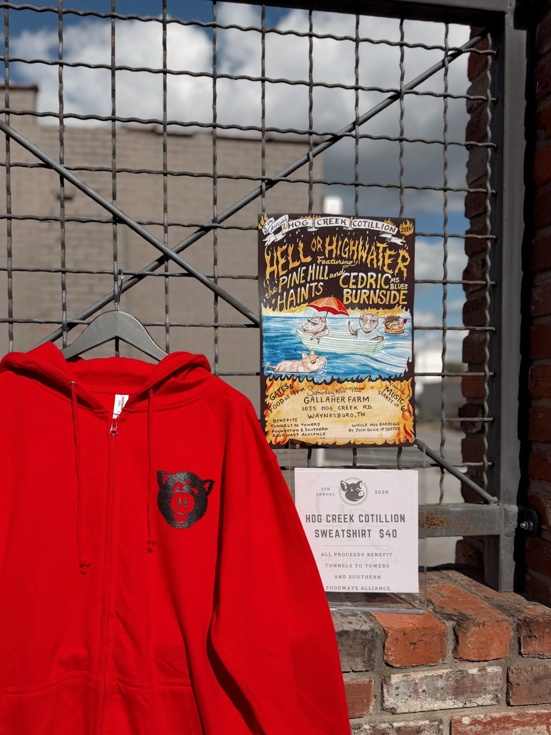 hcc 2026 sweathshirt and sign outside in red.jpg