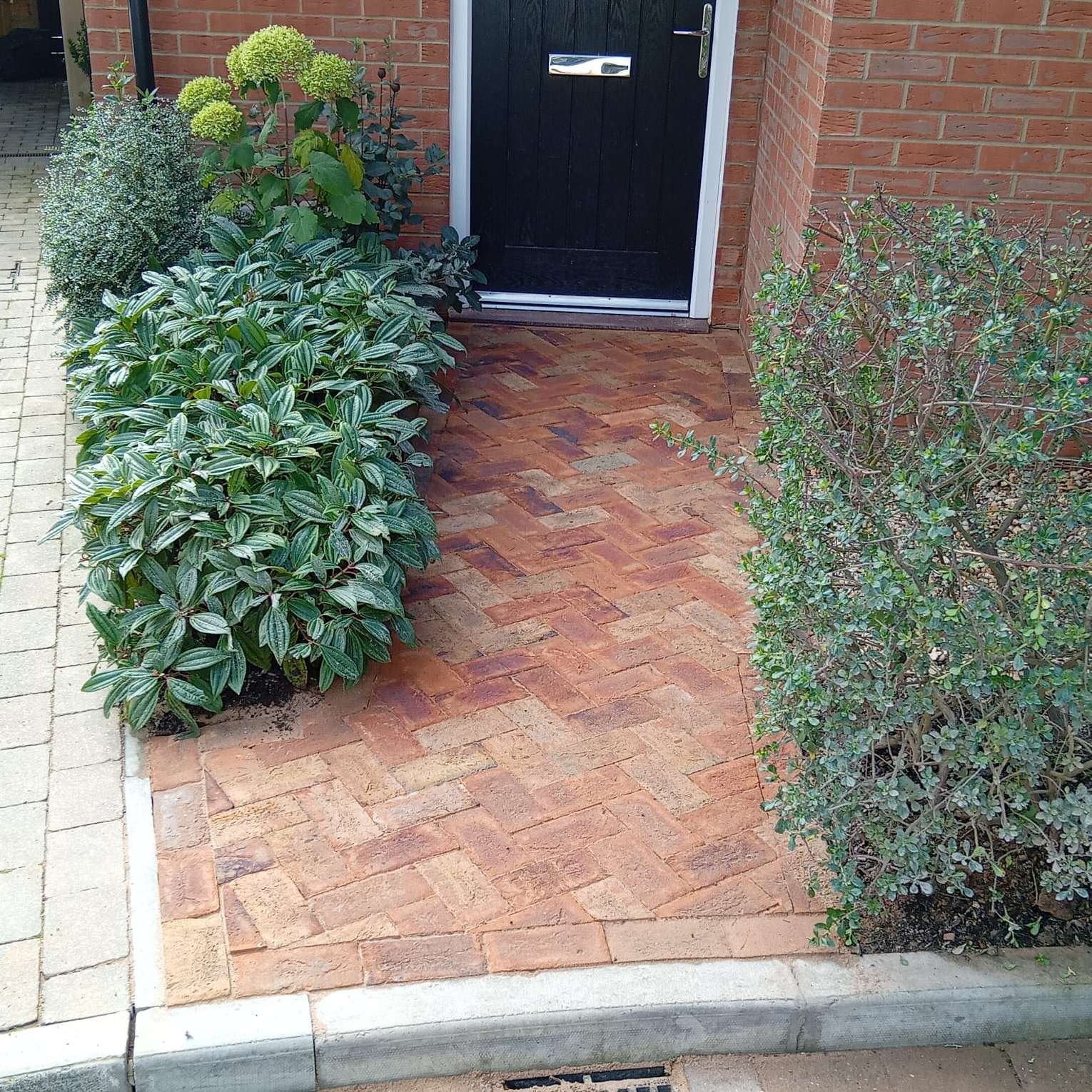Home entrance installed with rustic brick pavers for East Sussex home by AG Home & Gardens