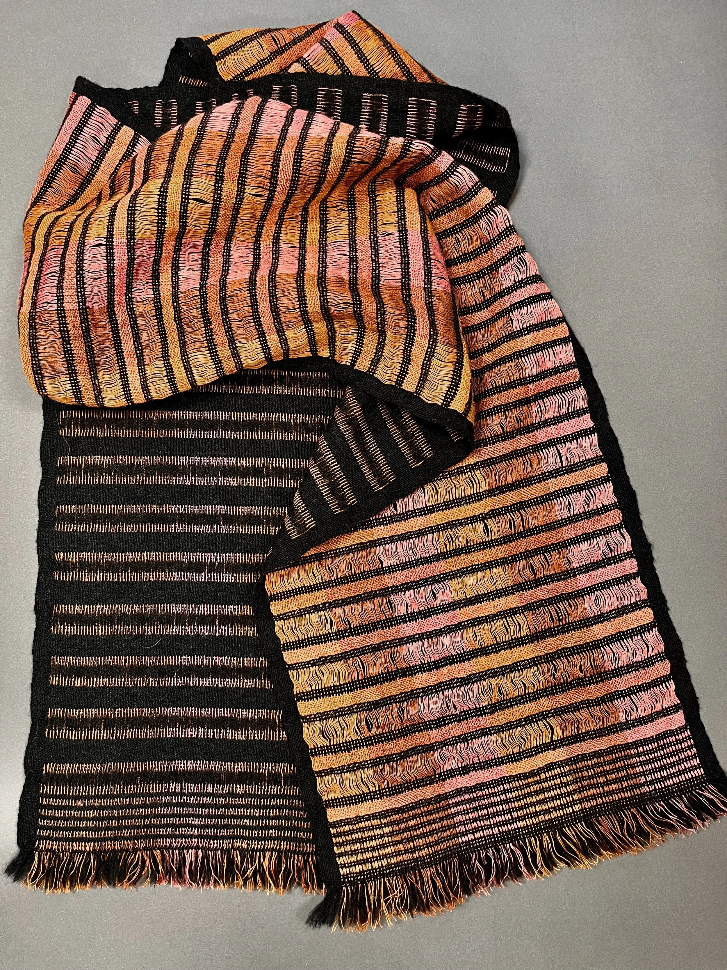 Black superfine merino wool deflects opposite stripes in three warm shades of linen