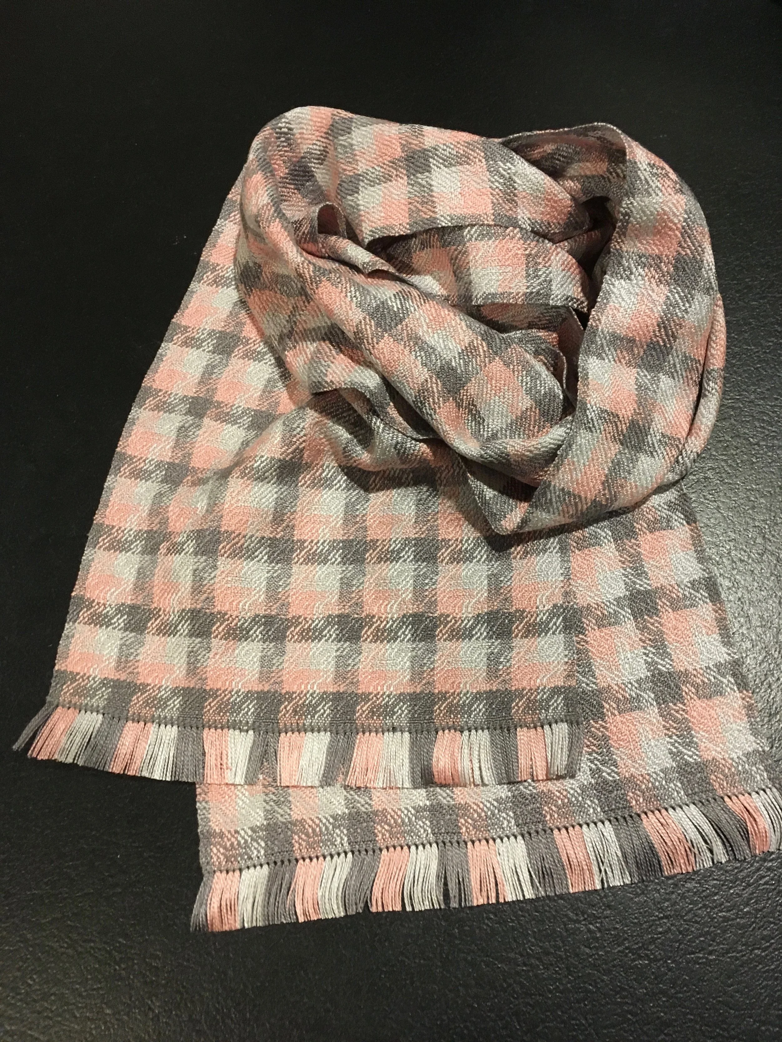 Tailored with a tightly hand-stitched hem and short fringe in pink & grey silk