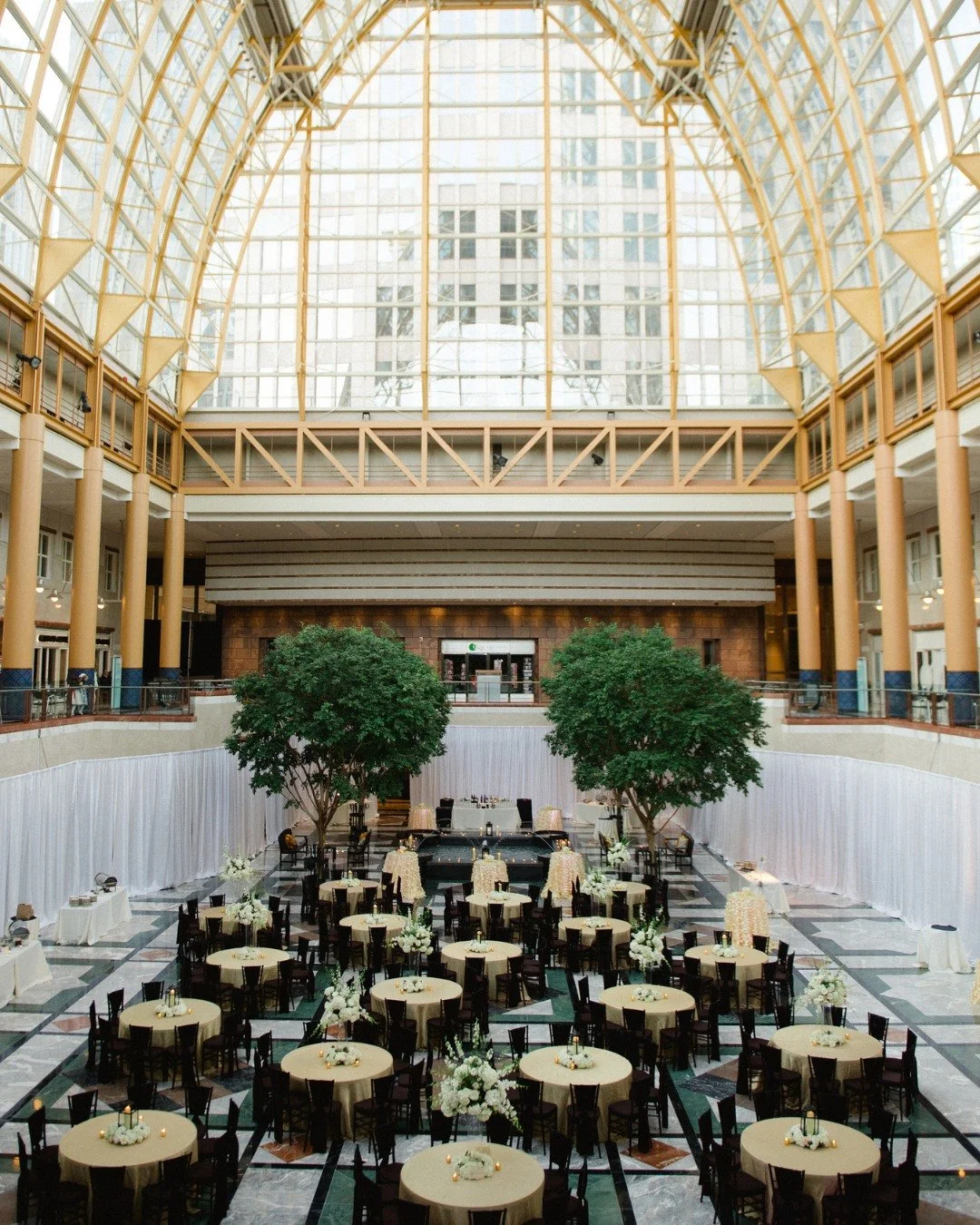 Under the glass and above expectations.

We love how Lauren and Drew&rsquo;s vision brought a sense of intimacy to our grand atrium. The soft glow of the centerpieces against the dramatic architecture created a reception atmosphere that felt both tim