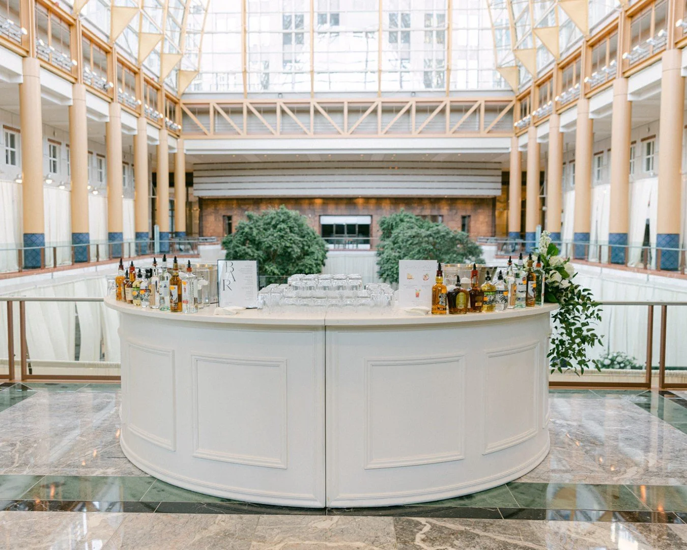 Elevating the standard cocktail hour.

We love how the Gabbs wedding utilized our space to create a seamless, elegant flow for their guests. Positioning these crisp white, curved bars on the mezzanine gives everyone the perfect excuse to sip a signat