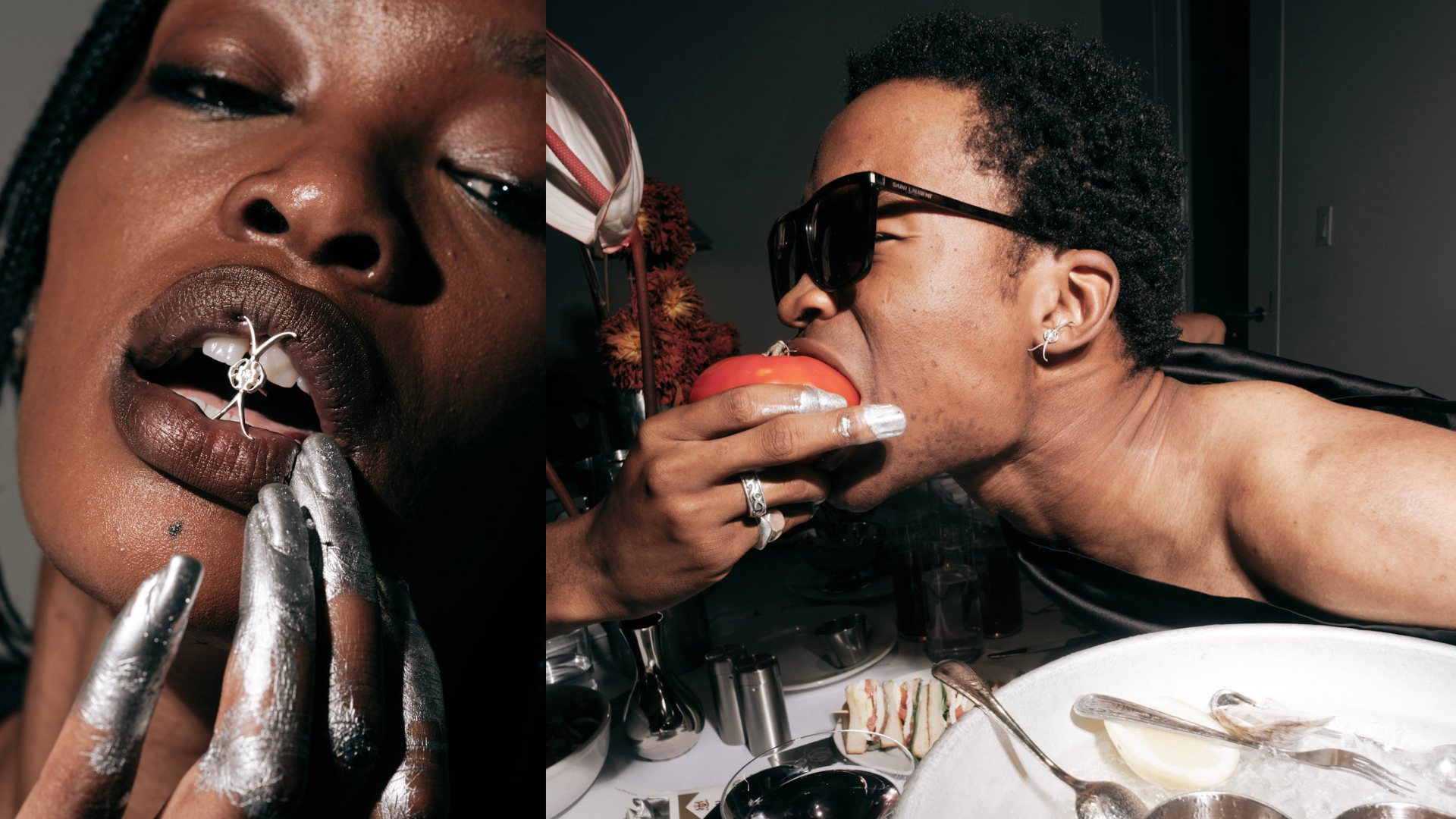 Close-up of a woman with dark skin and braided hair, wearing metallic silver lipstick and jewelry, touching her lips with metallic silver-painted fingers. The right side shows a man with dark skin, short curly hair, wearing black sunglasses, eating a slice of tomato with his mouth wide open, wearing rings and earrings, with a plate of food in front of him.