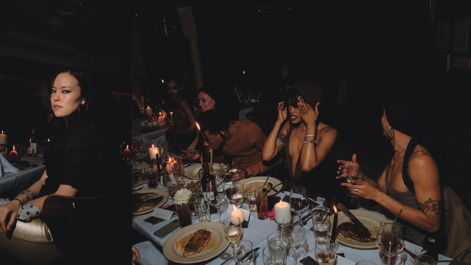 People enjoying a dinner party at a long table, with candles and food, in a dimly lit restaurant or banquet hall.