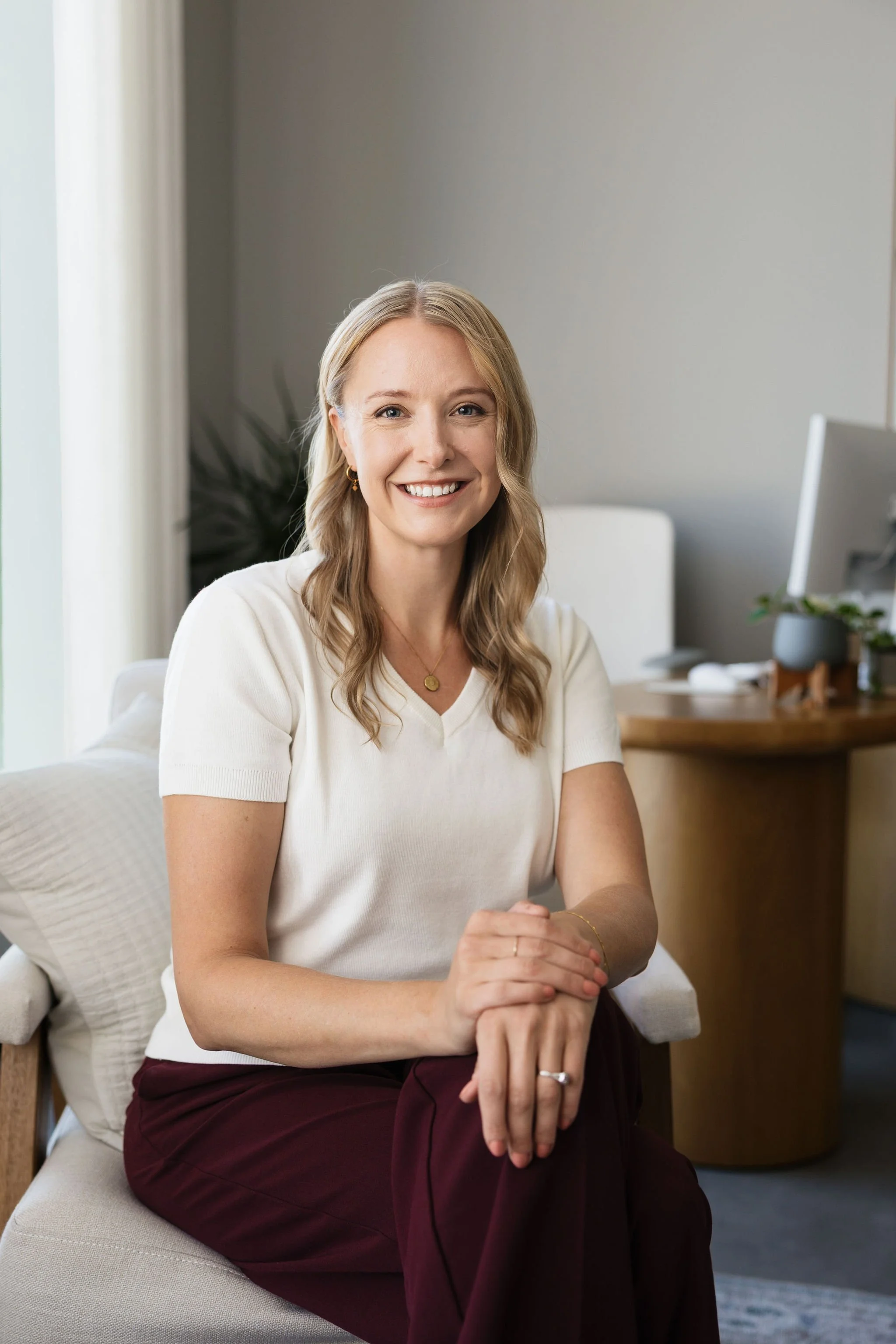 Dr. Erica Stene Winkler, licensed therapist offering in-person and telehealth counseling in Fargo, North Dakota, seated in her office