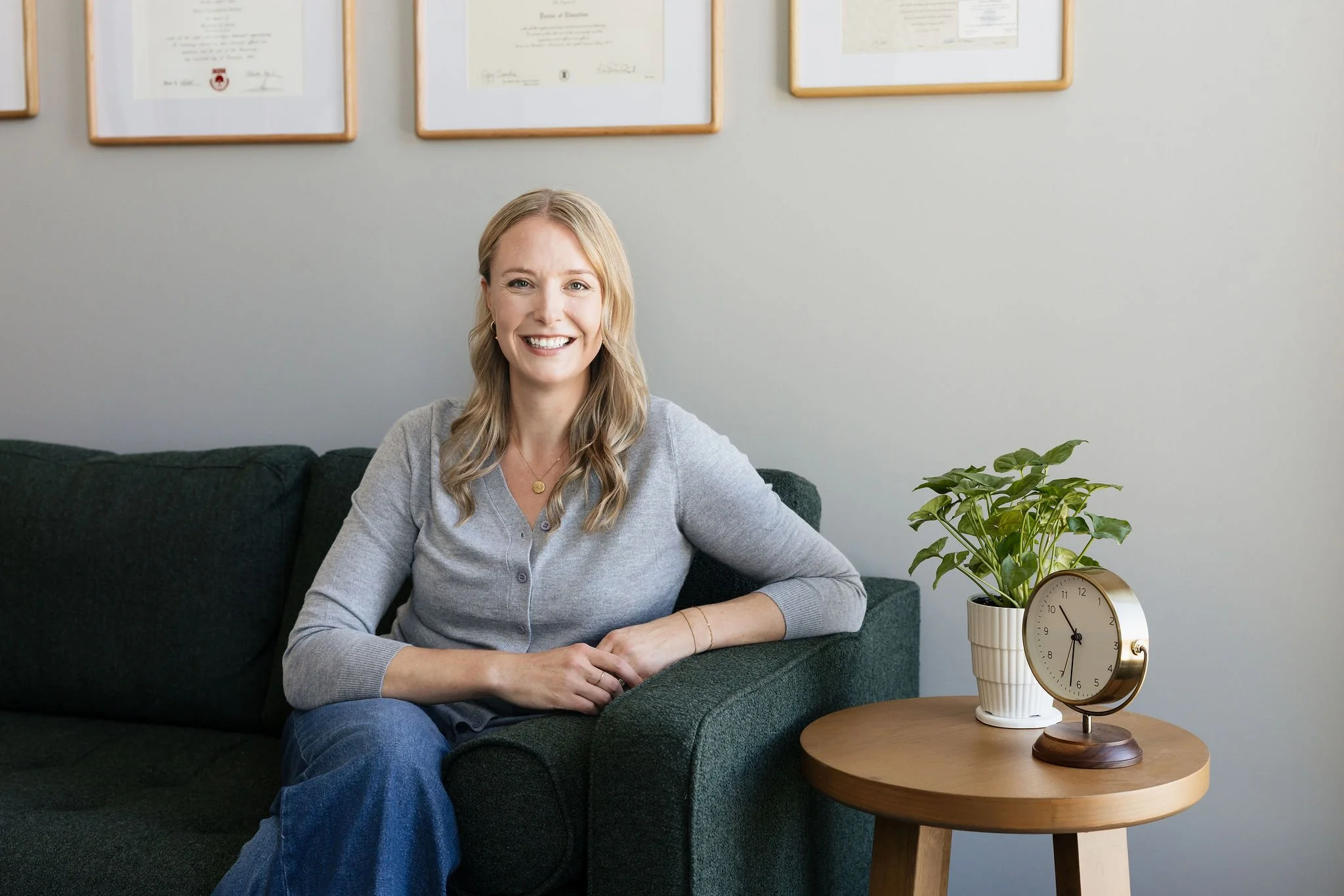 Dr. Erica Stene Winkler, EdD, licensed counselor and founder of On By Therapy, smiling while seated in a therapy office in Fargo, ND