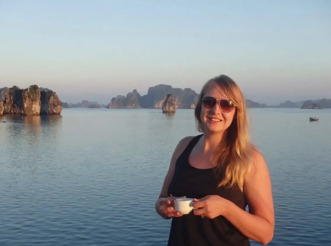 Erica traveling and enjoying a quiet moment with a cup of coffee, grounding her work as a warm, genuine therapist serving the Fargo–Moorhead region.