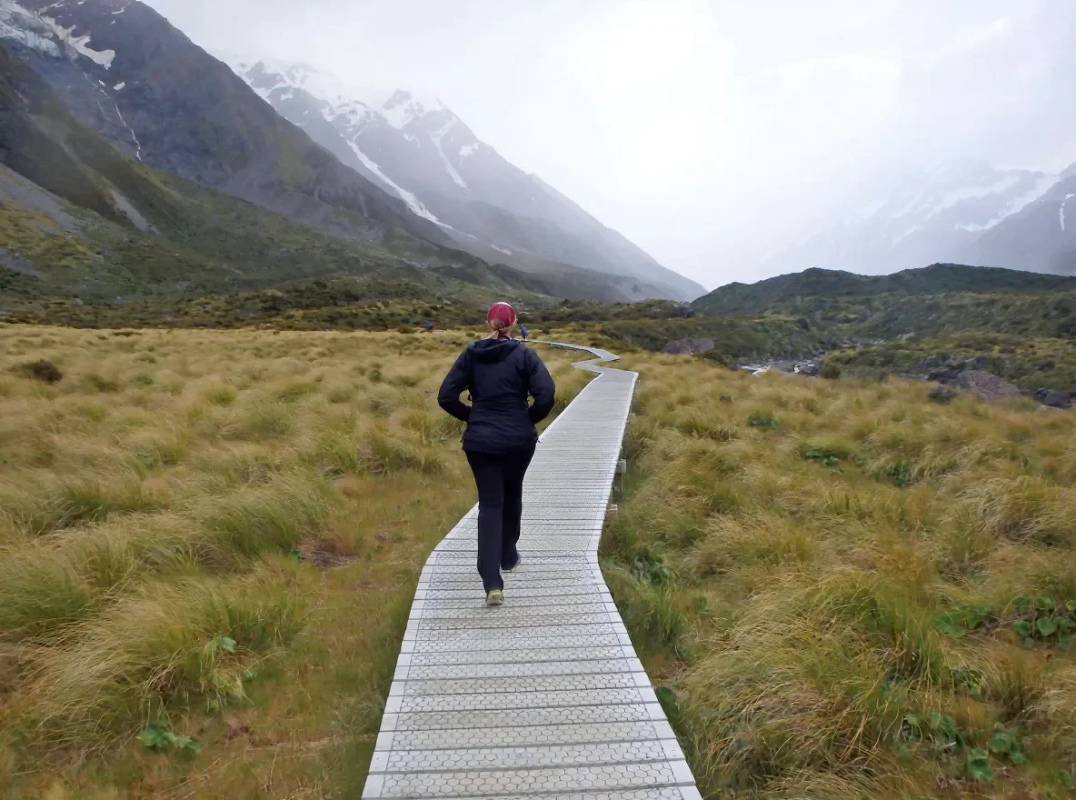 Erica hiking in New Zealand, embracing exploration and reflection—values she brings to her therapy work with clients across North Dakota and Minnesota.